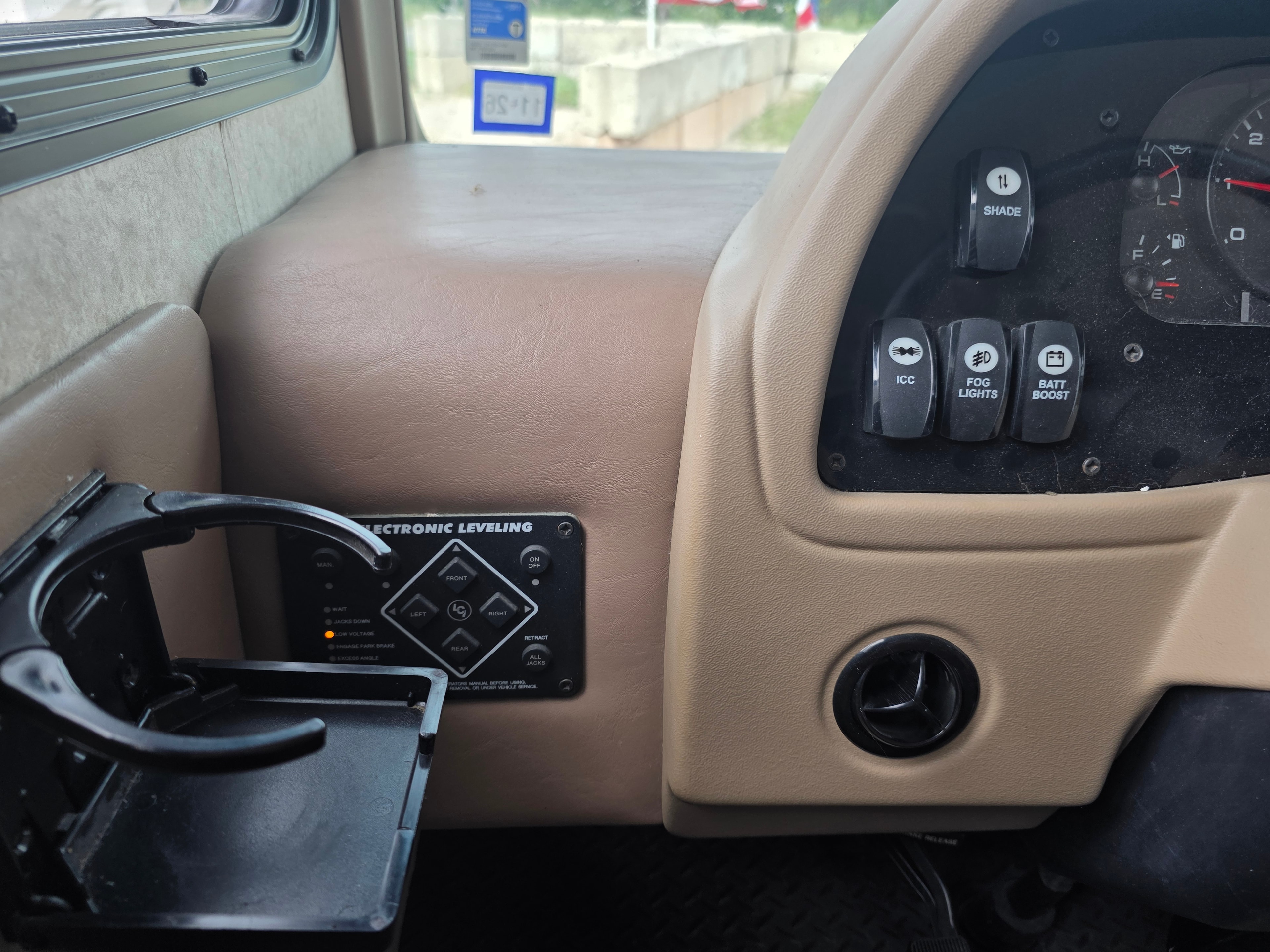 2014 Forest River Georgetown – driver side dash with electronic leveling panel, shade, ICC, fog lights and battery boost switches