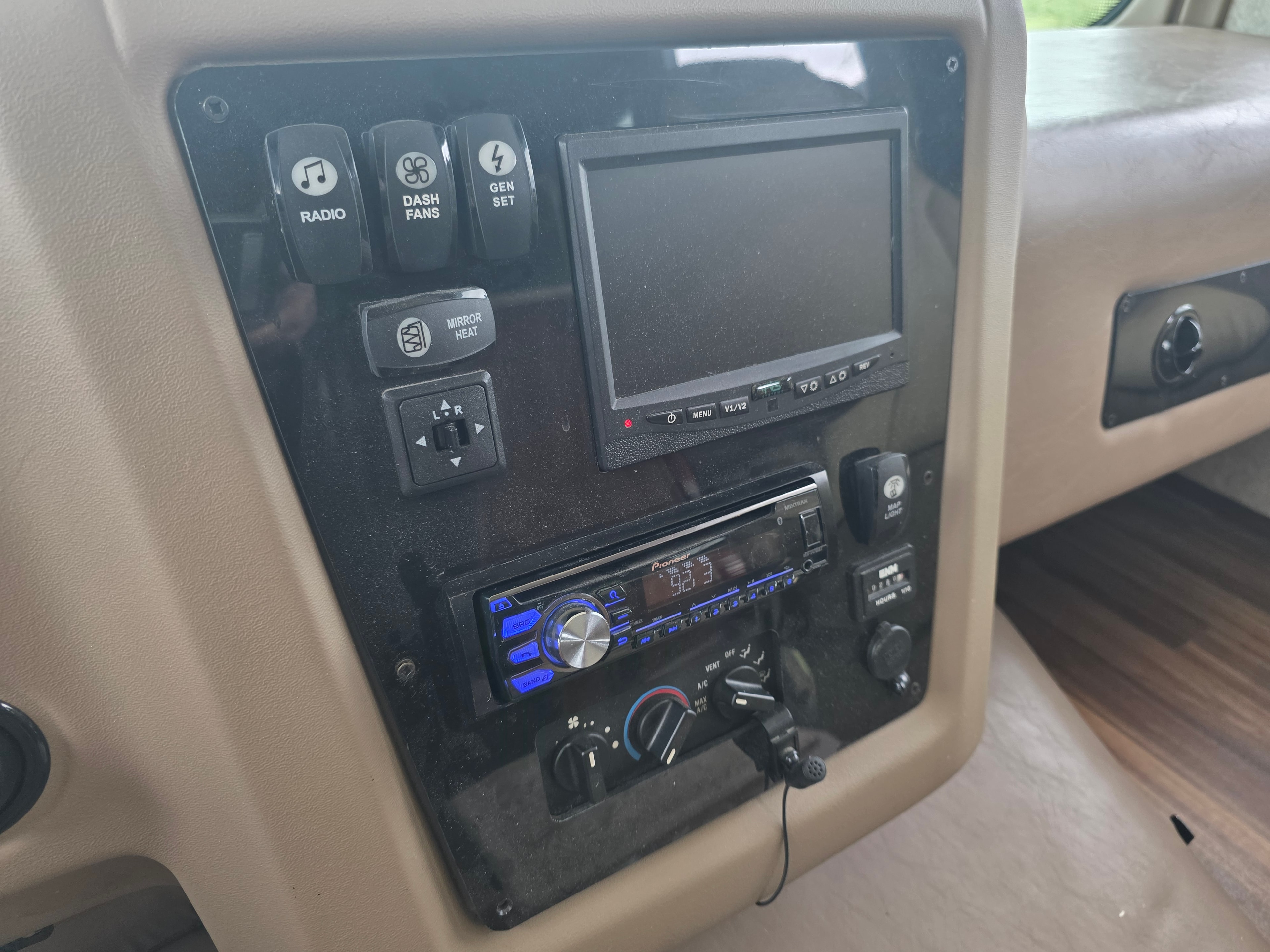 2014 Forest River Georgetown – center console with Pioneer stereo, backup camera monitor, radio, dash fans, gen set and AC controls