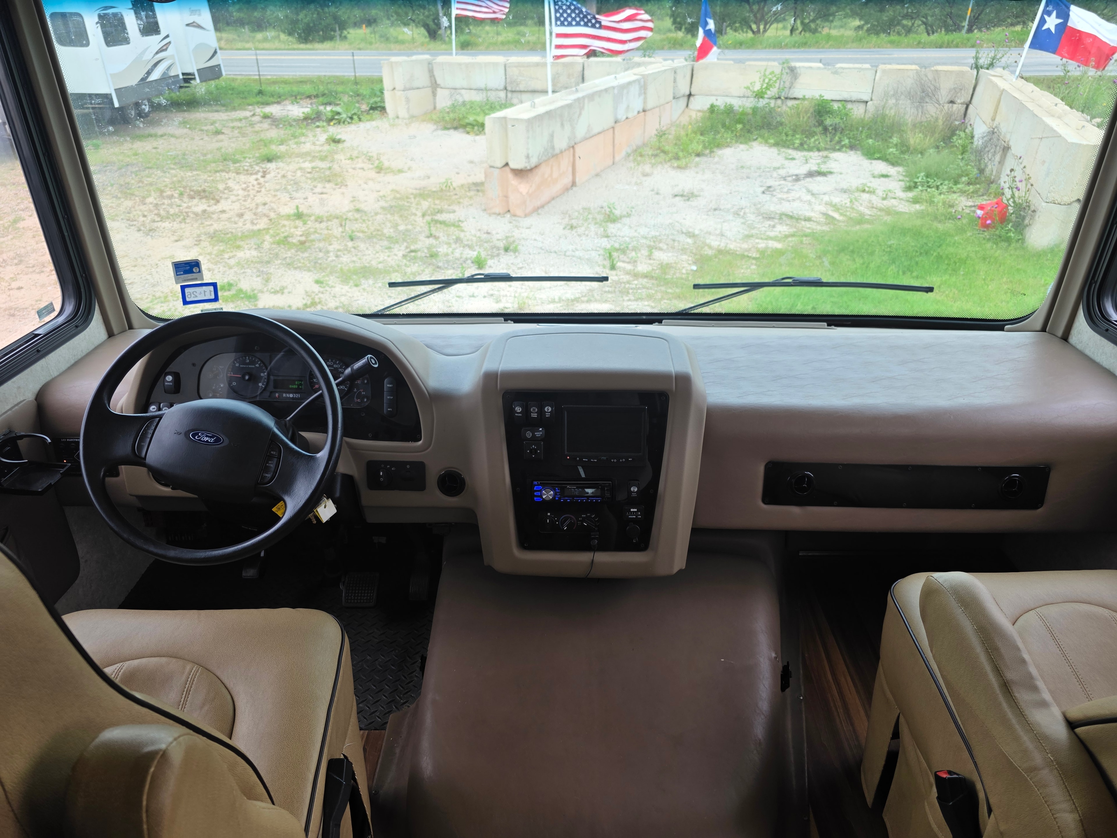 2014 Forest River Georgetown – full cockpit view with Ford steering wheel, center console, captain chairs and panoramic windshield