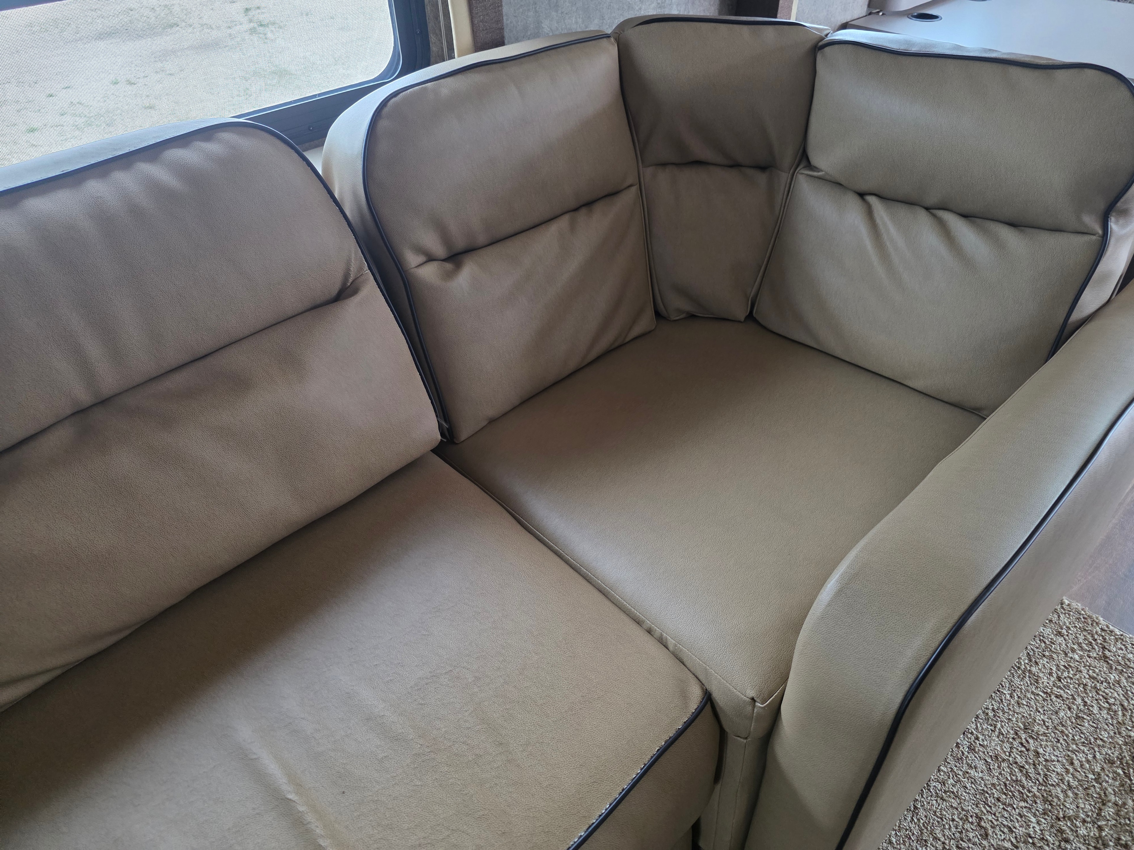 2014 Forest River Georgetown – large fold-out sofa in tan leather showing clean condition with no peeling