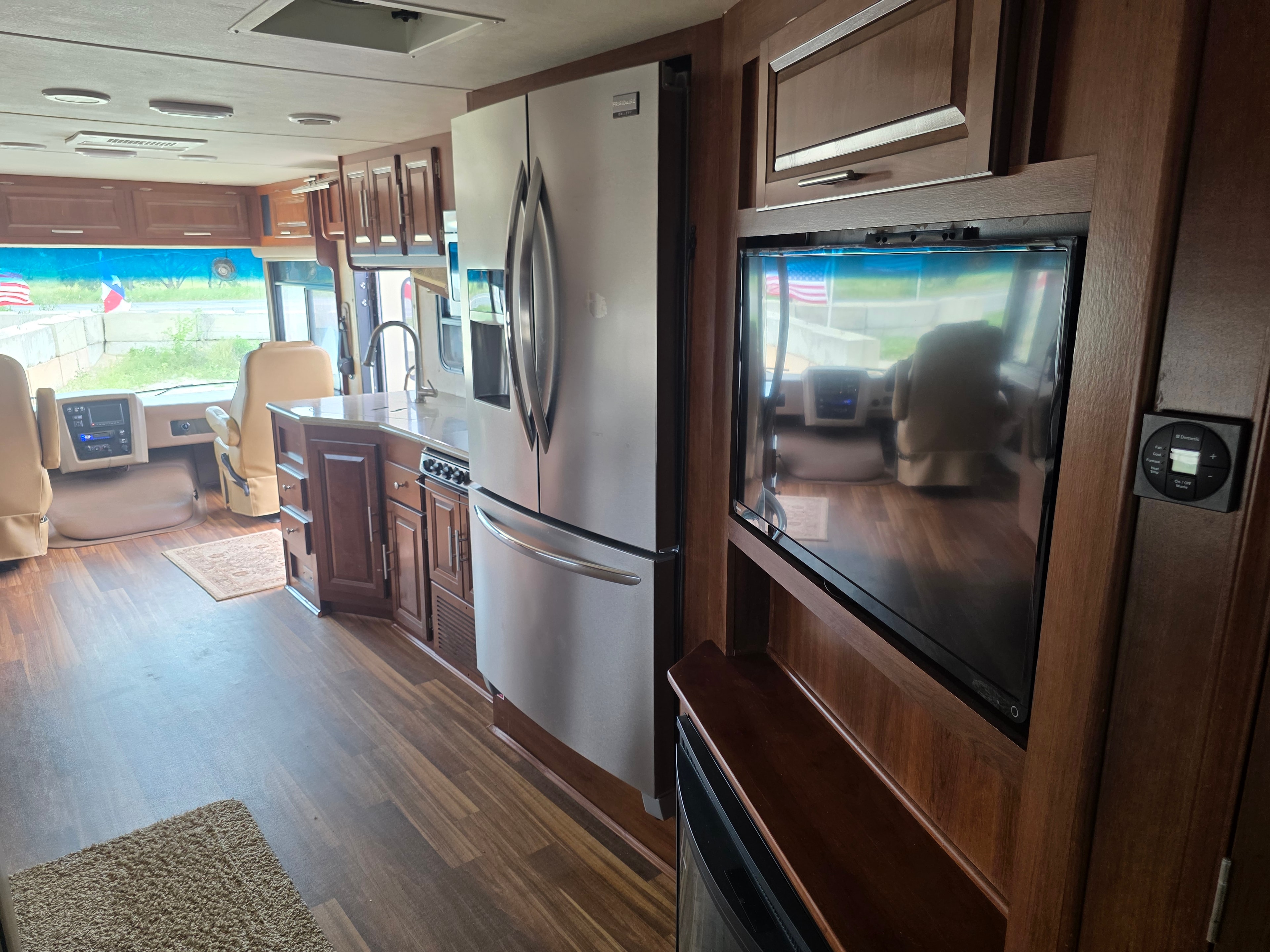 2014 Forest River Georgetown – full interior view with residential fridge, living area TV, wood flooring and cockpit
