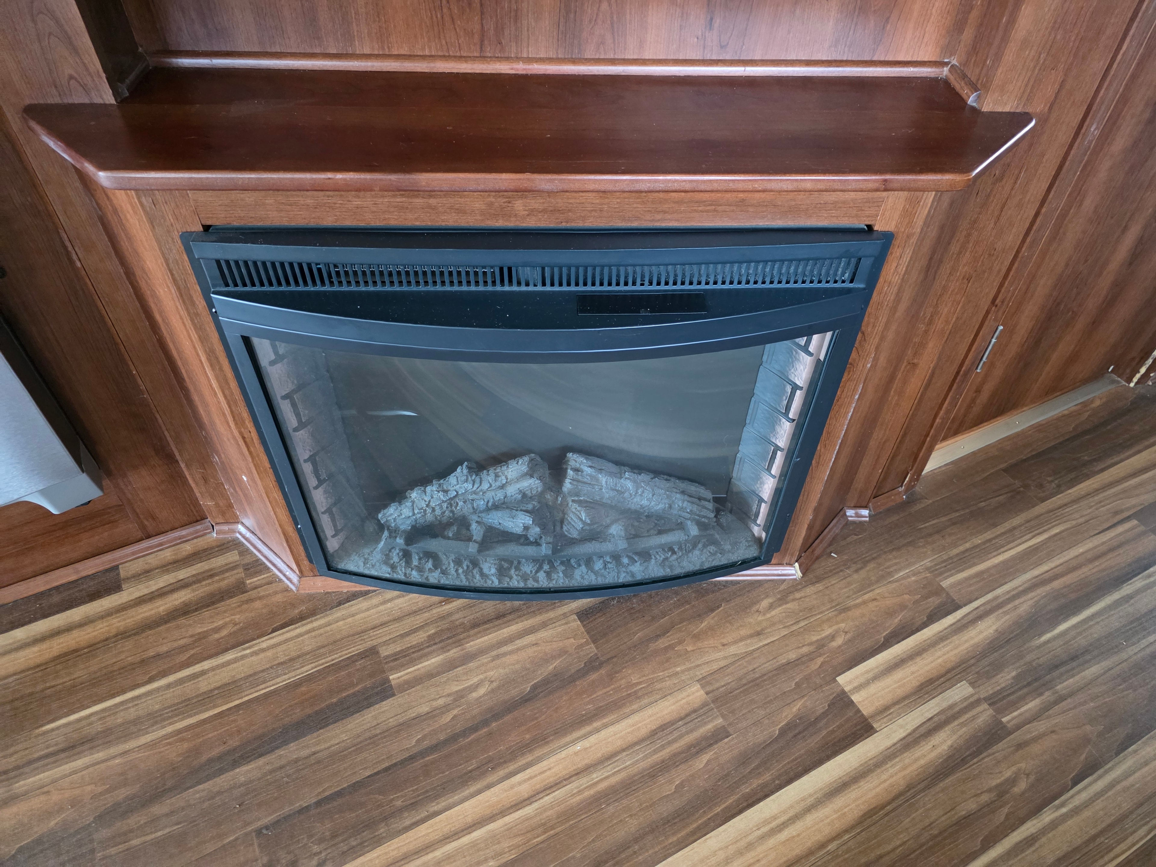 2014 Forest River Georgetown – electric fireplace with wood surround mantel and wood-look flooring