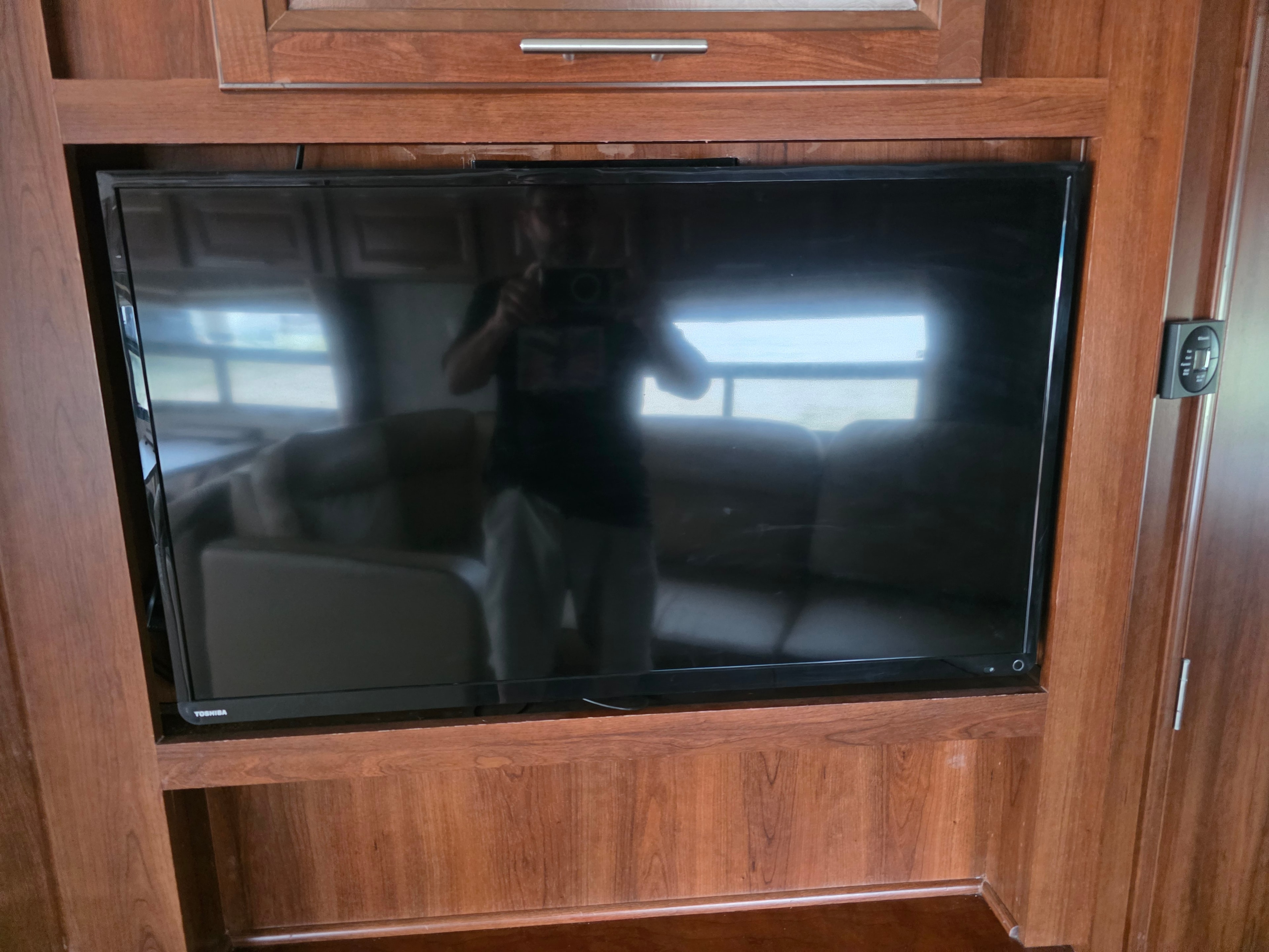 2014 Forest River Georgetown – Toshiba flat screen TV mounted in wood cabinetry with Dometic thermostat