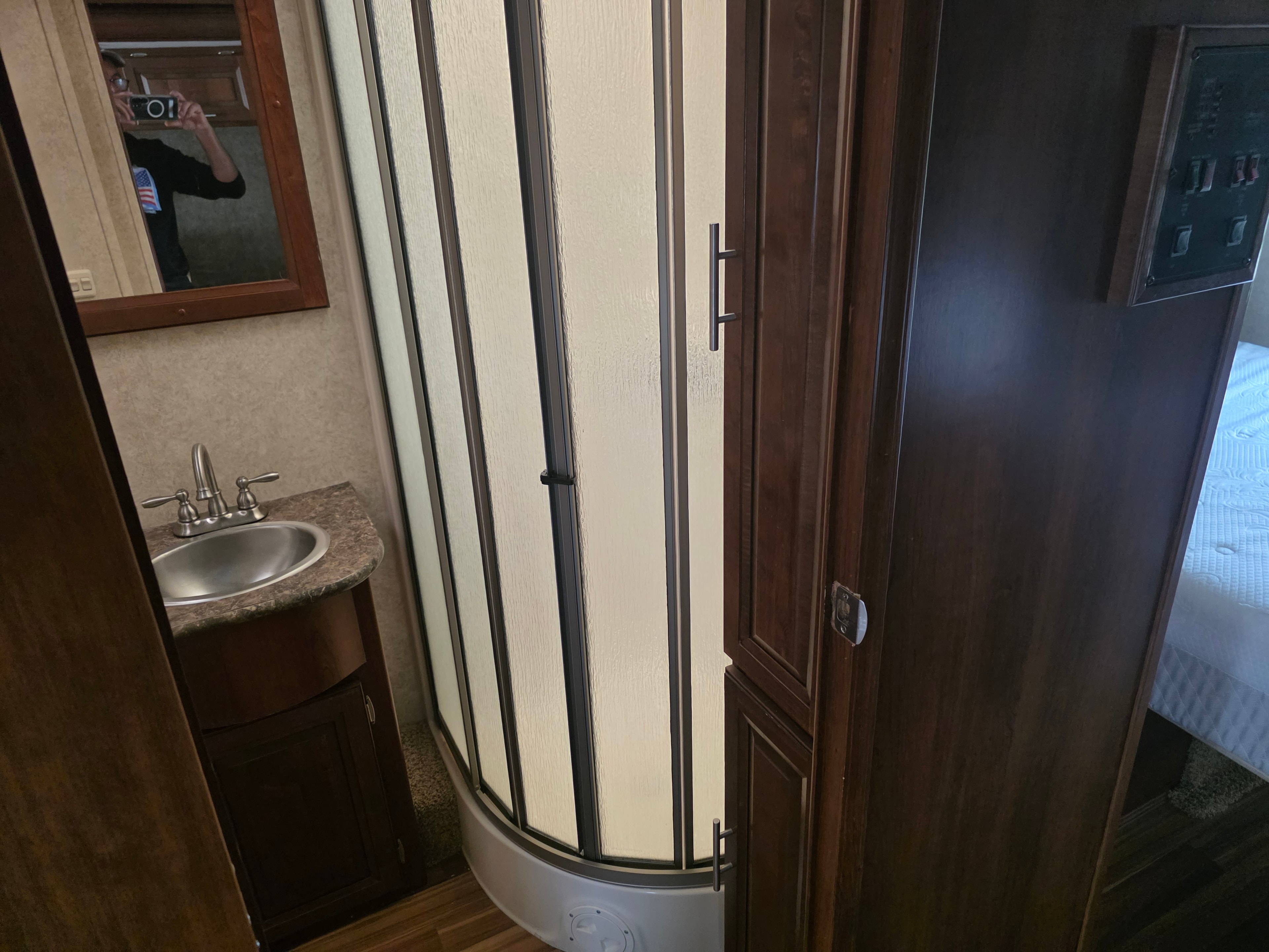 2014 Forest River Georgetown – curved shower stall with frosted door, vanity sink and bedroom view