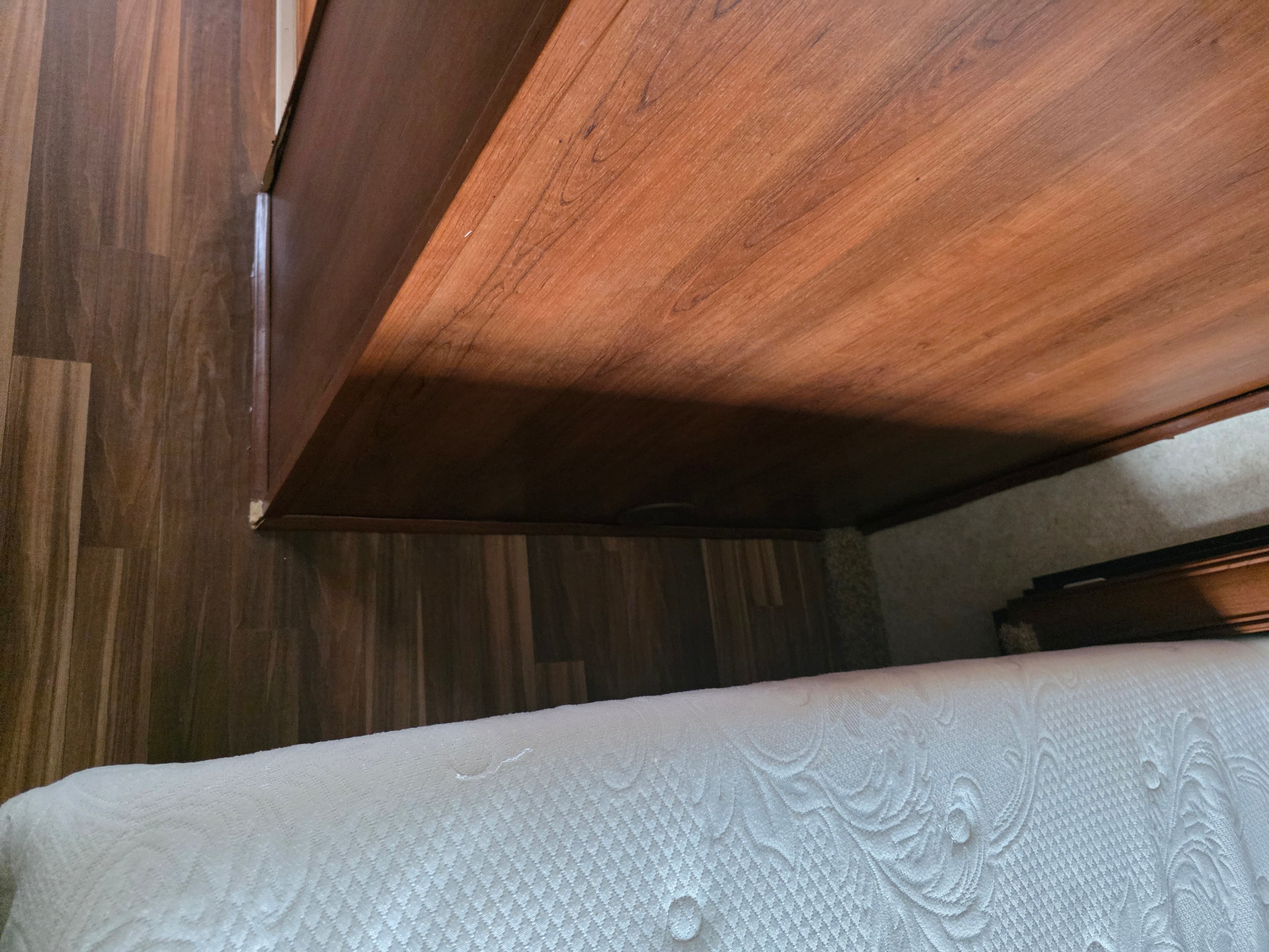 2014 Forest River Georgetown – bed slide extended showing queen mattress, wood ceiling panel and walk-around space