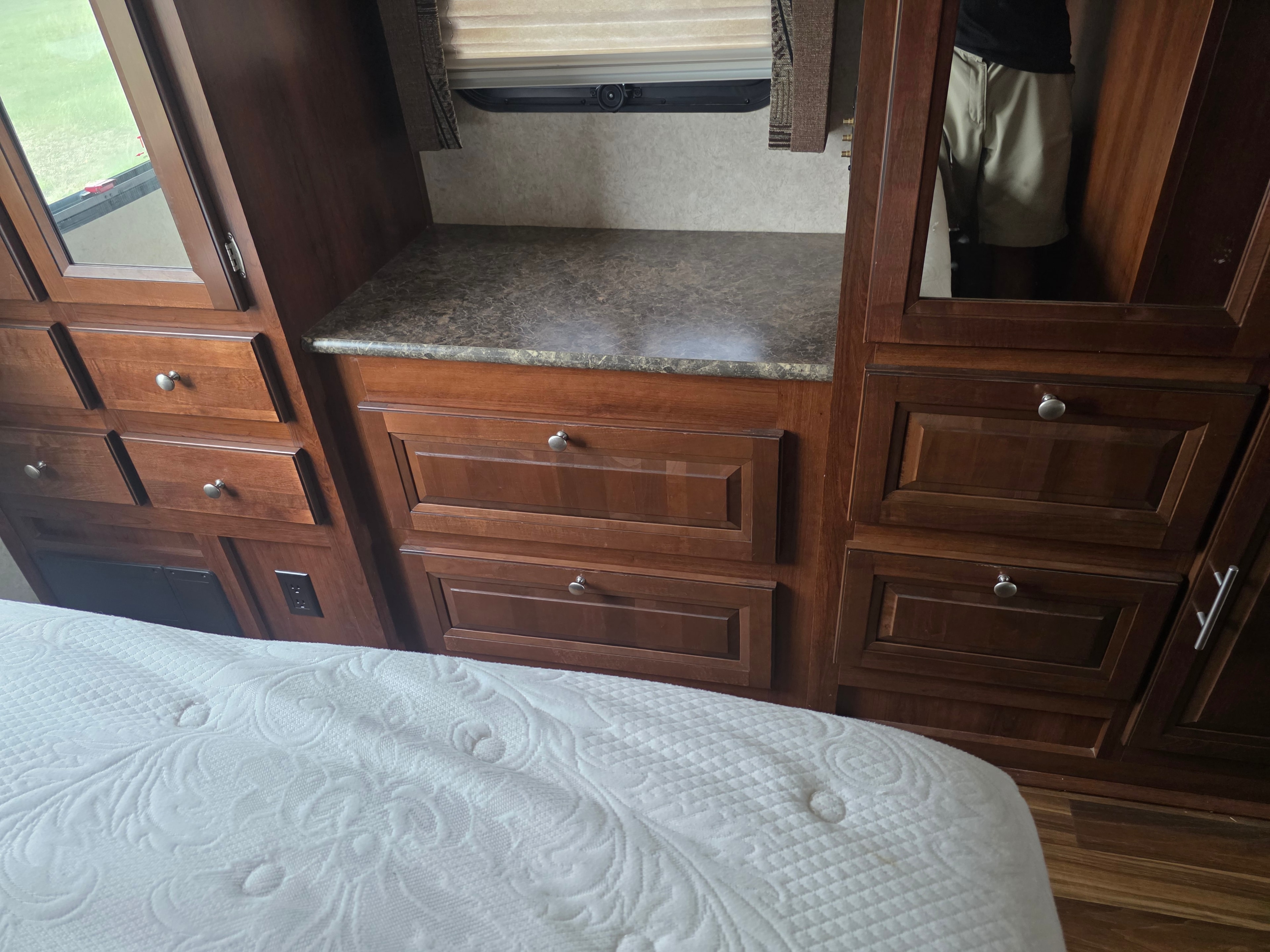 2014 Forest River Georgetown – bedroom dresser close-up with granite countertop, mirrored wardrobes and multiple drawers
