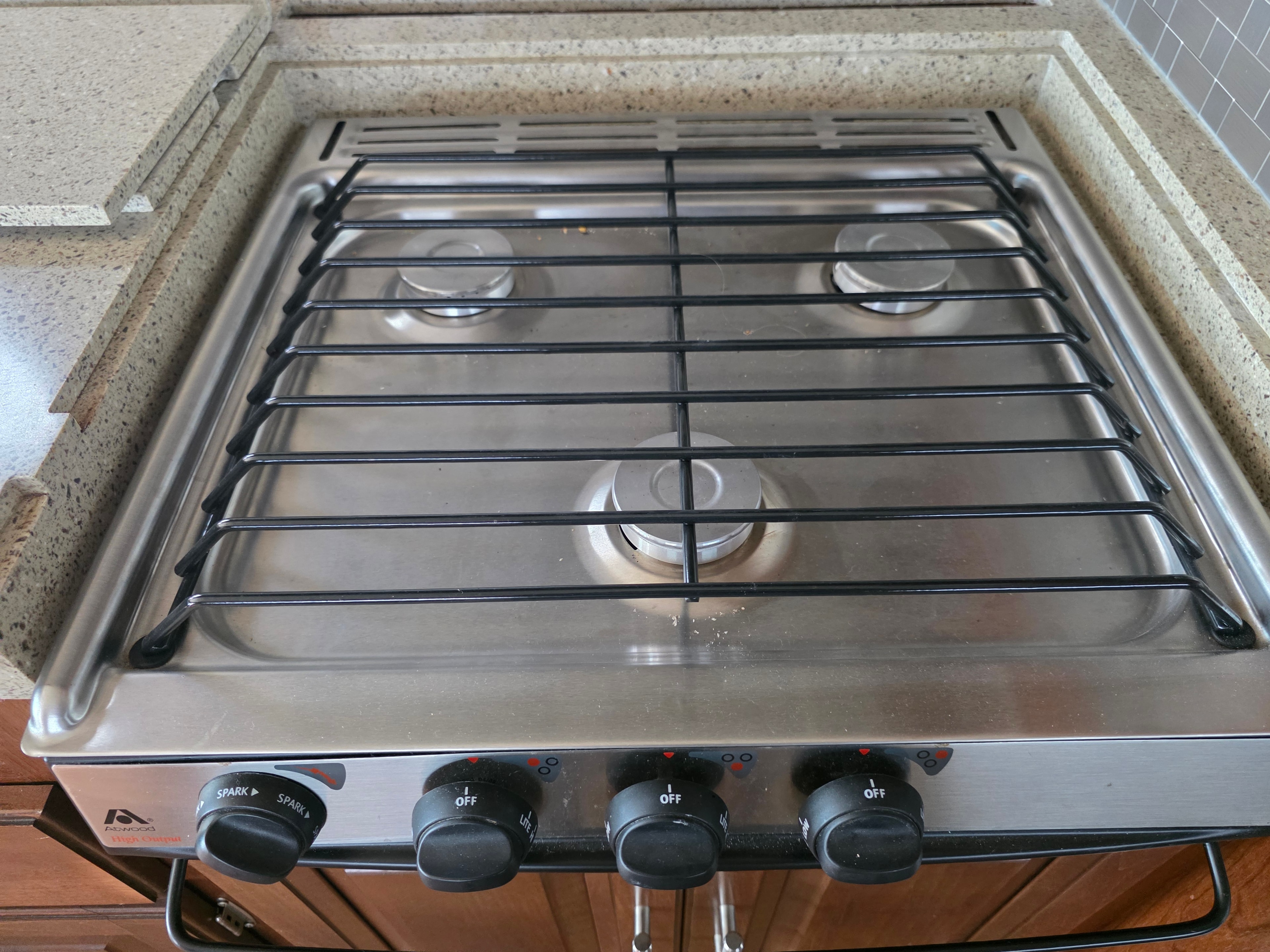 2014 Forest River Georgetown – Atwood 3-burner stainless gas cooktop with grill guards, looks barely used