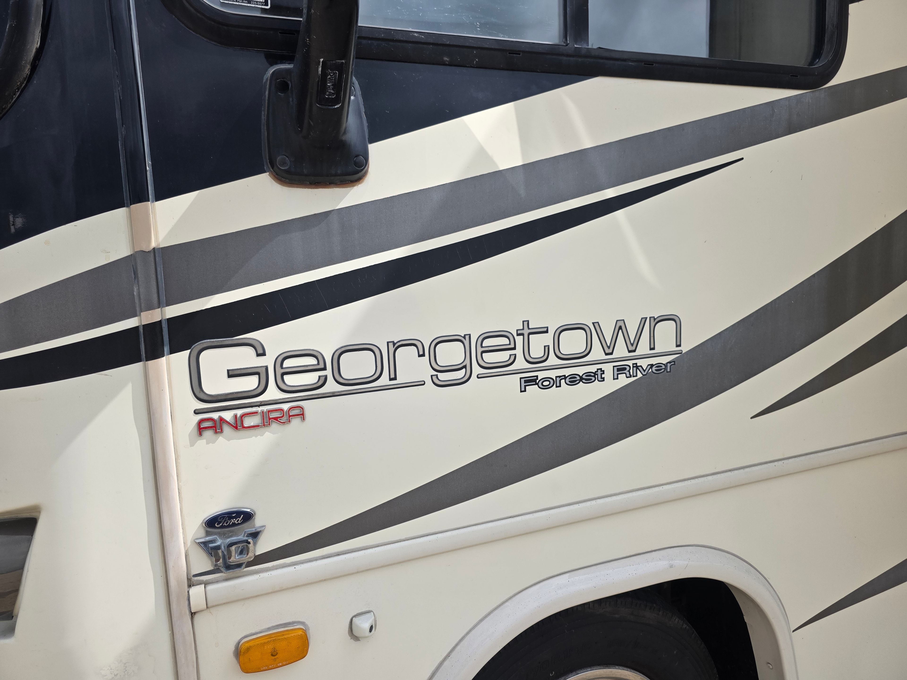 2014 Forest River Georgetown – Georgetown Forest River and Ancira badge close-up with Ford chassis emblem