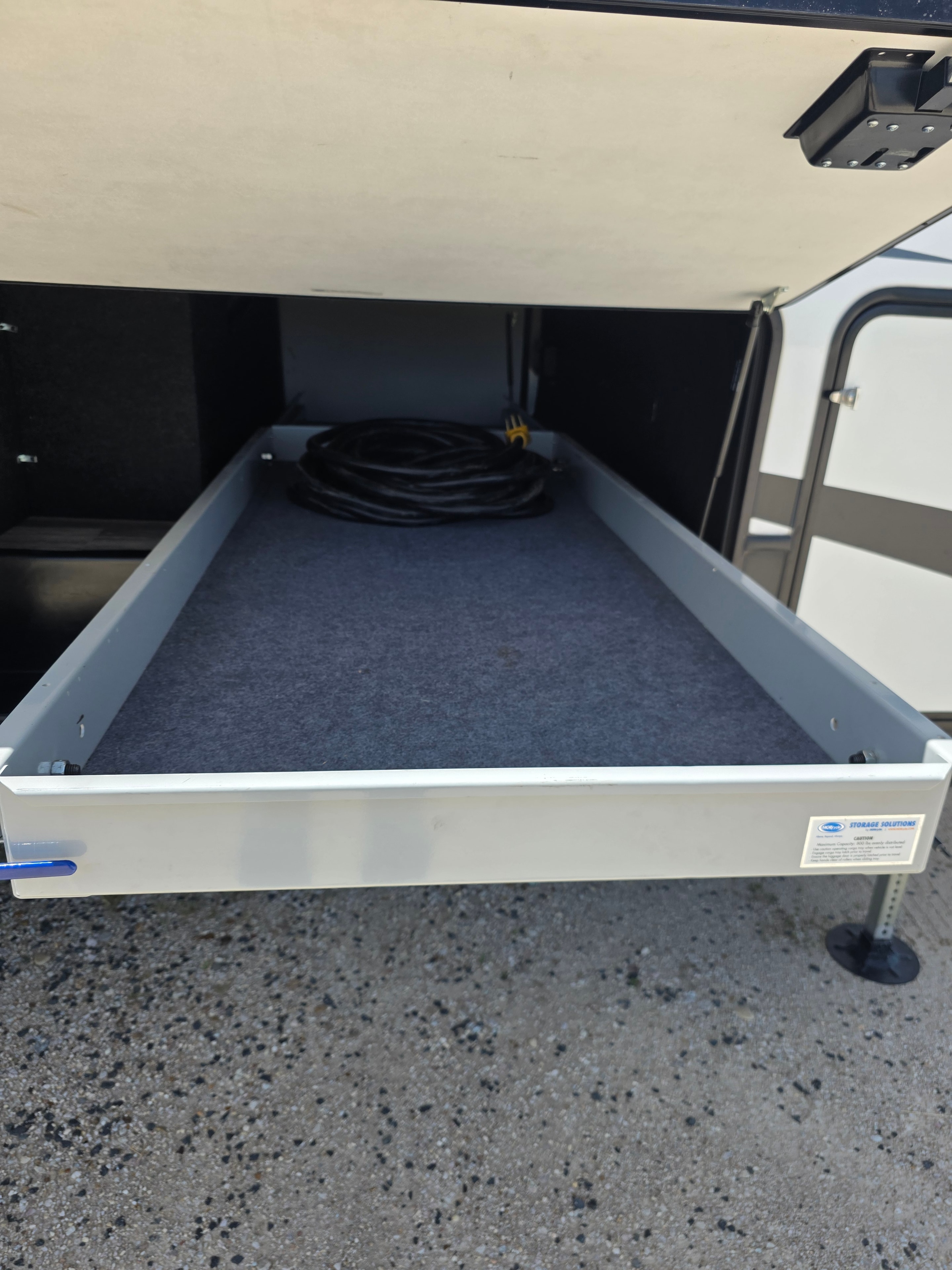 2021 Yukon Dutchmen 320RL – slide-out storage tray with power cord