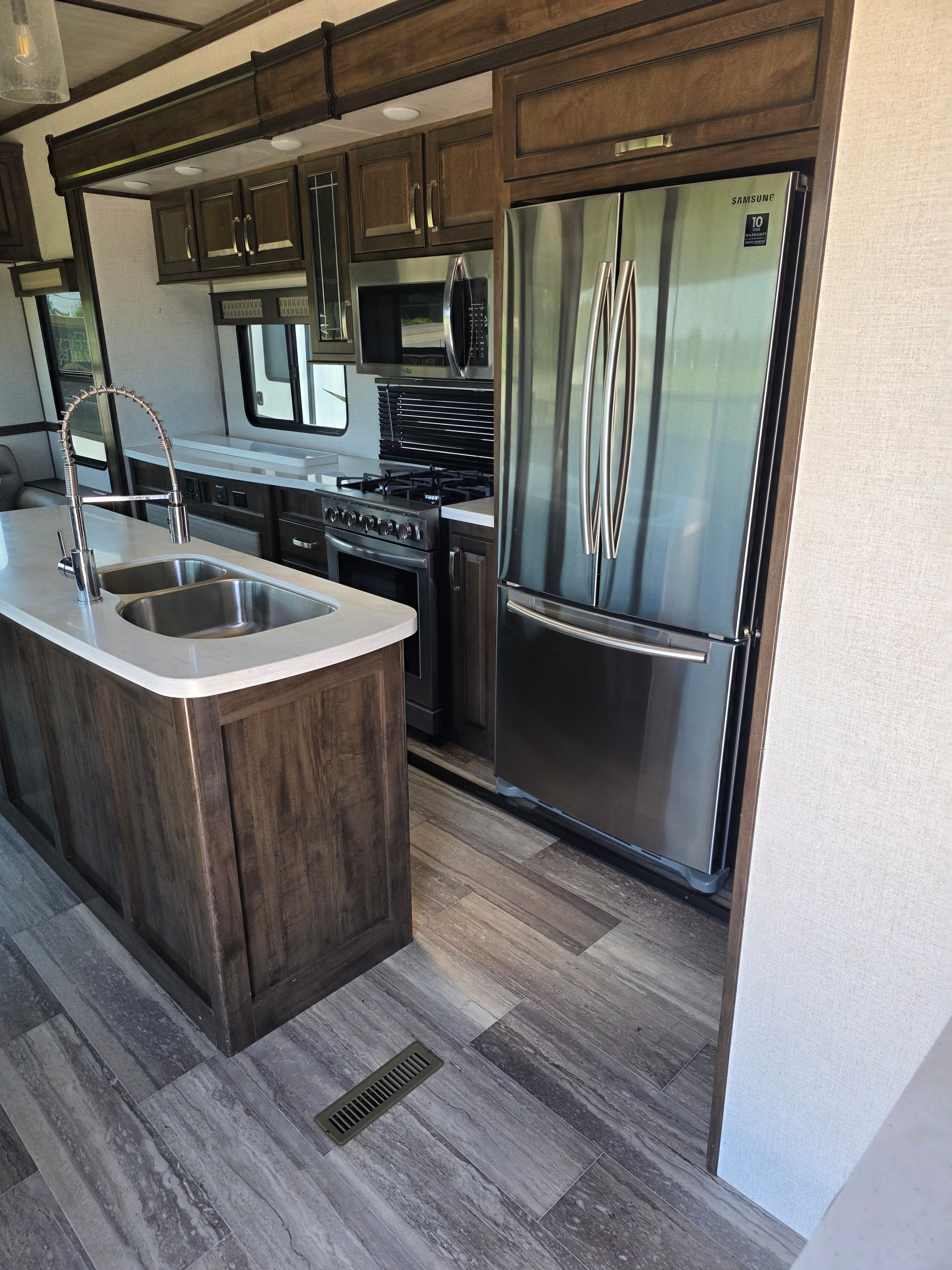 2021 Yukon Dutchmen 320RL – kitchen with Samsung French door refrigerator and island sink