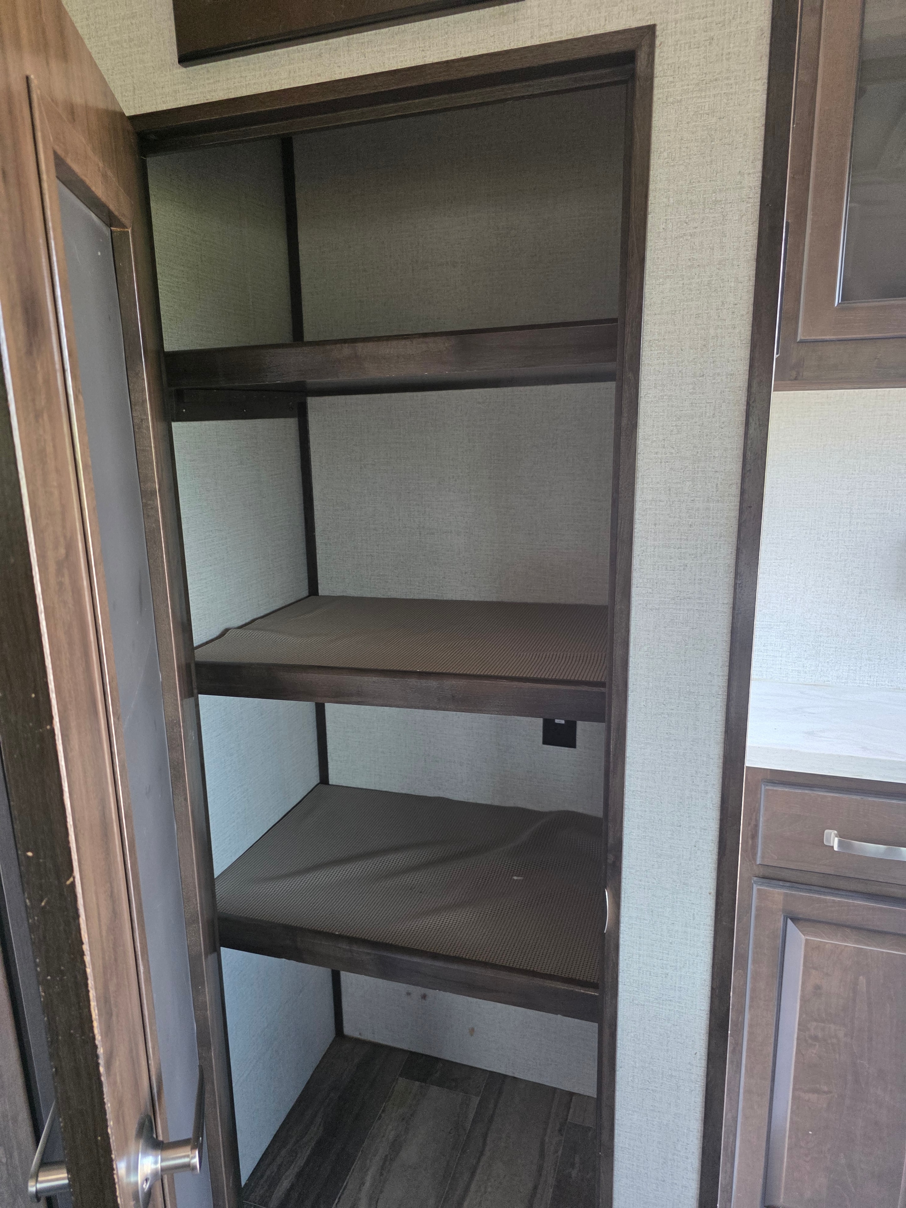 2021 Yukon Dutchmen 320RL – under-counter cabinet storage compartment