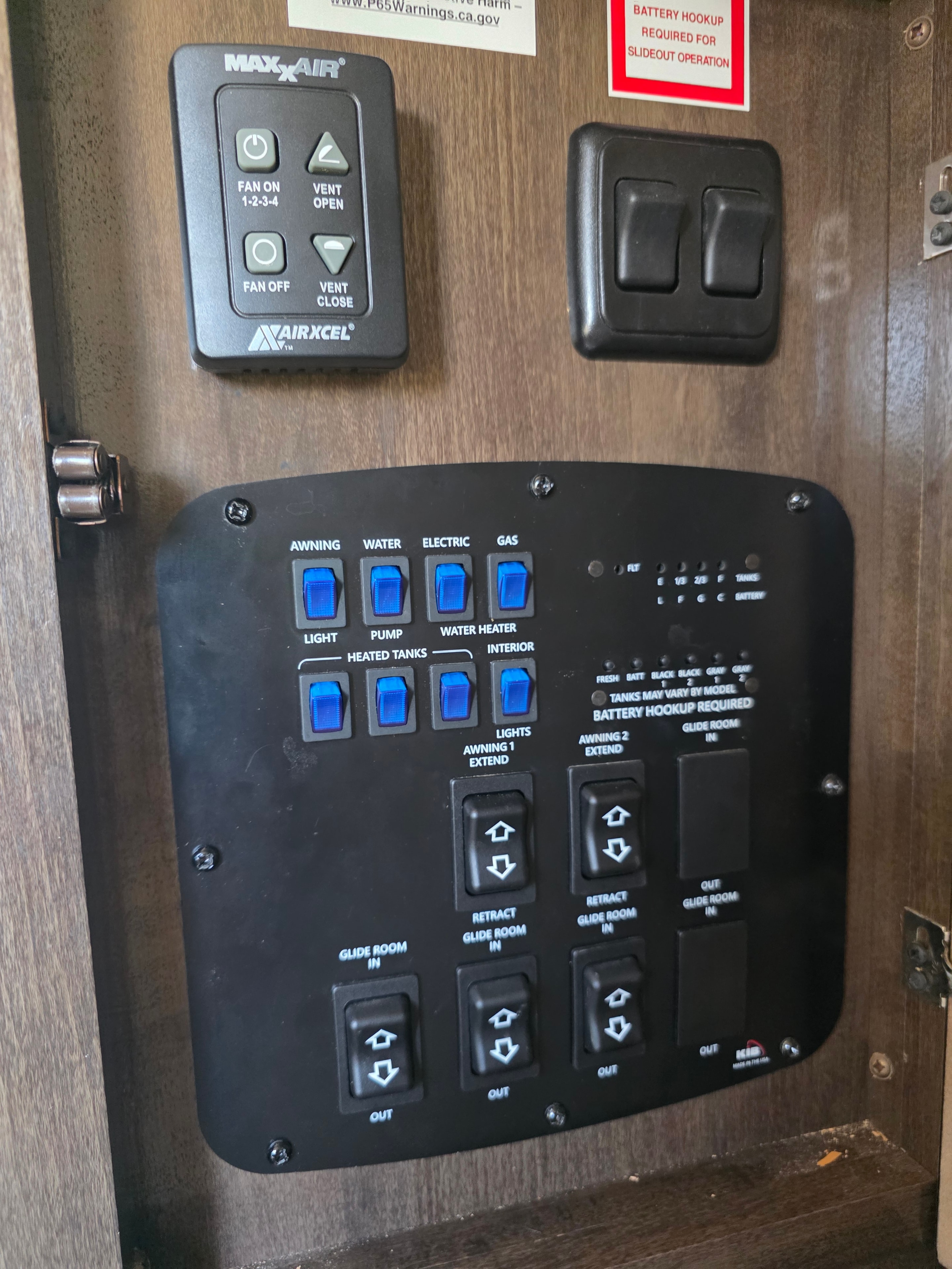 2021 Yukon Dutchmen 320RL – RV control panel with blue-lit switches and MaxxAir remote