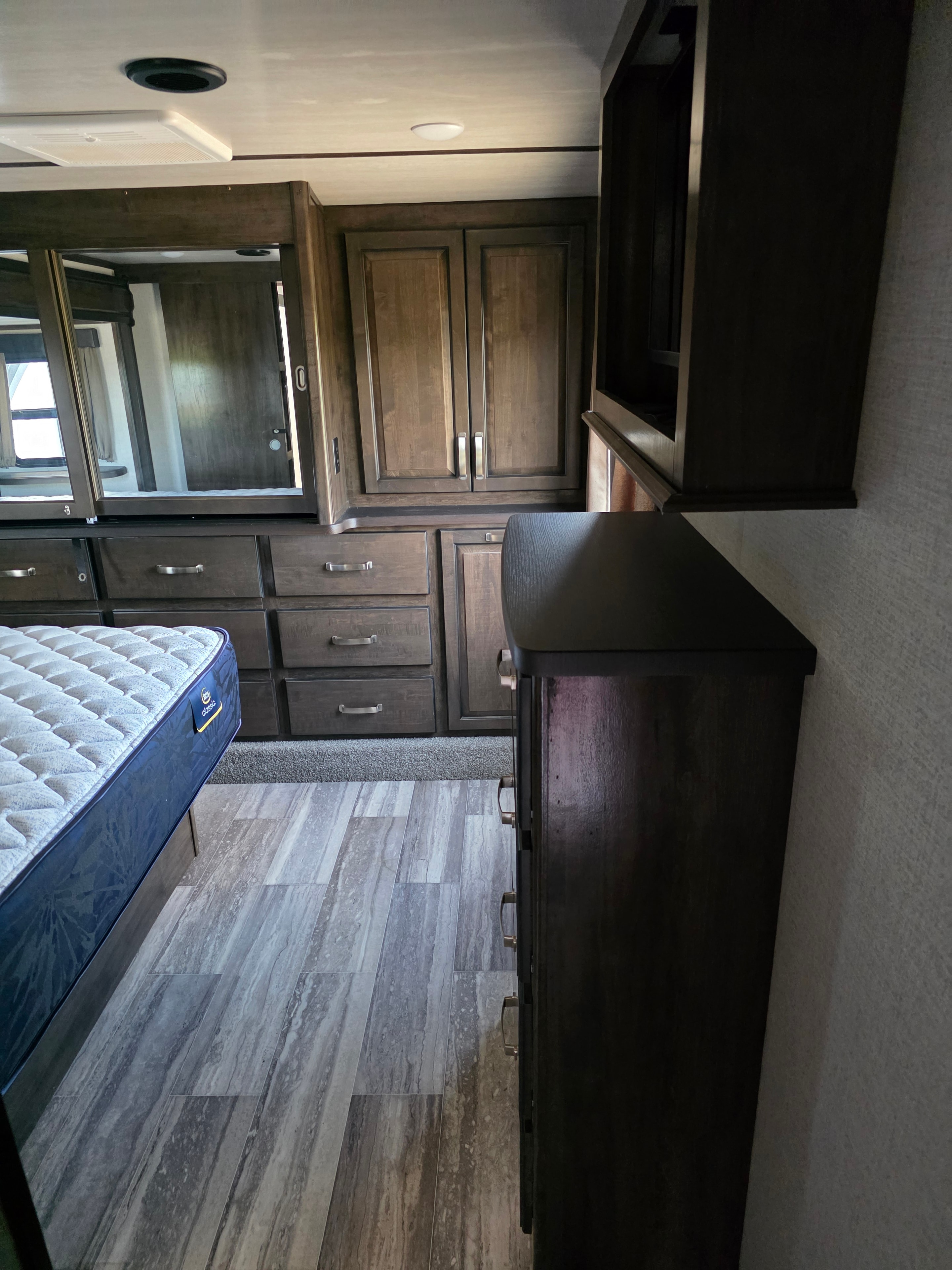 2021 Yukon Dutchmen 320RL – bedroom cabinetry with wine cooler and Serta mattress