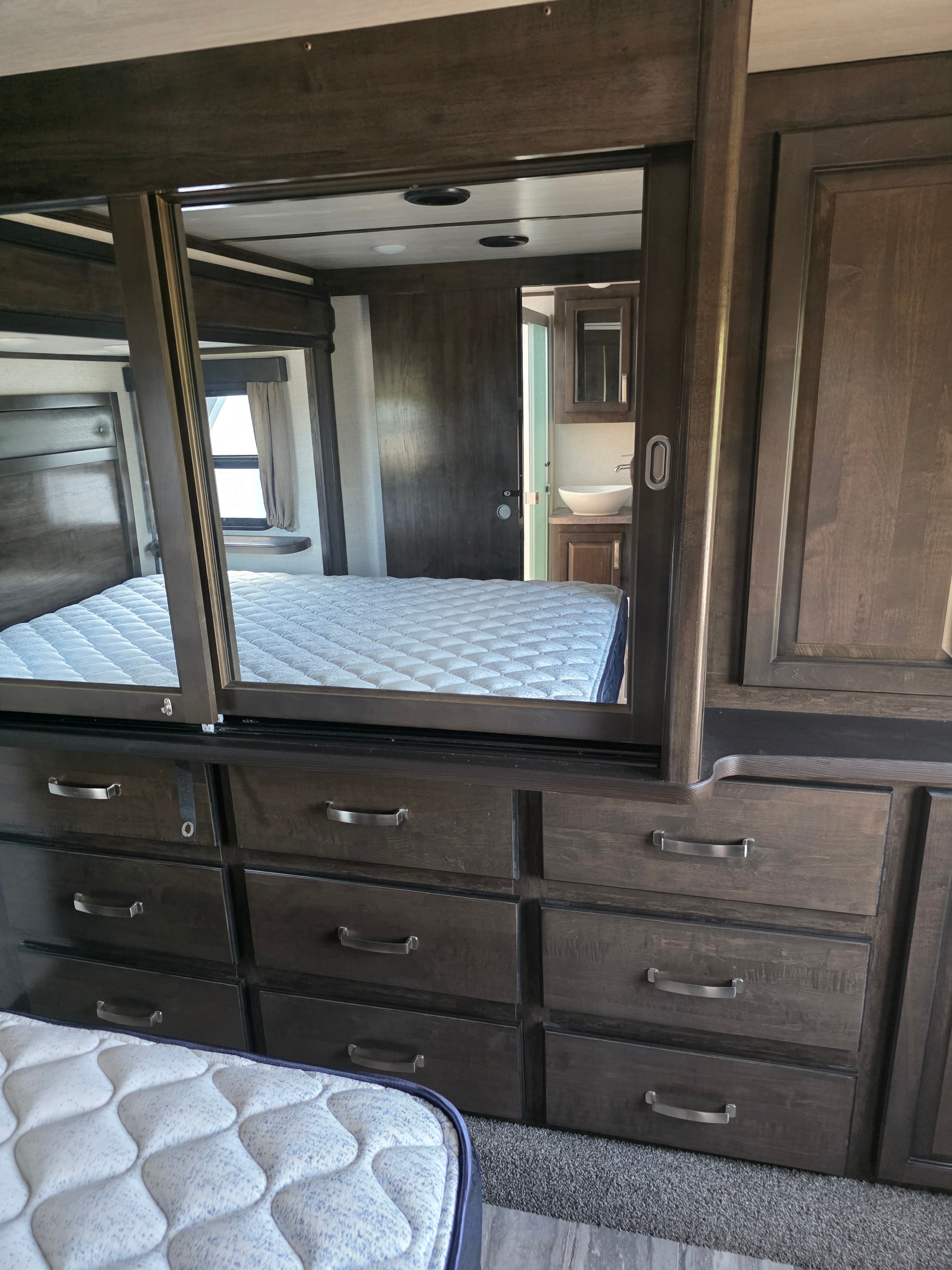 2021 Yukon Dutchmen 320RL – bedroom dresser drawers and cabinetry wall