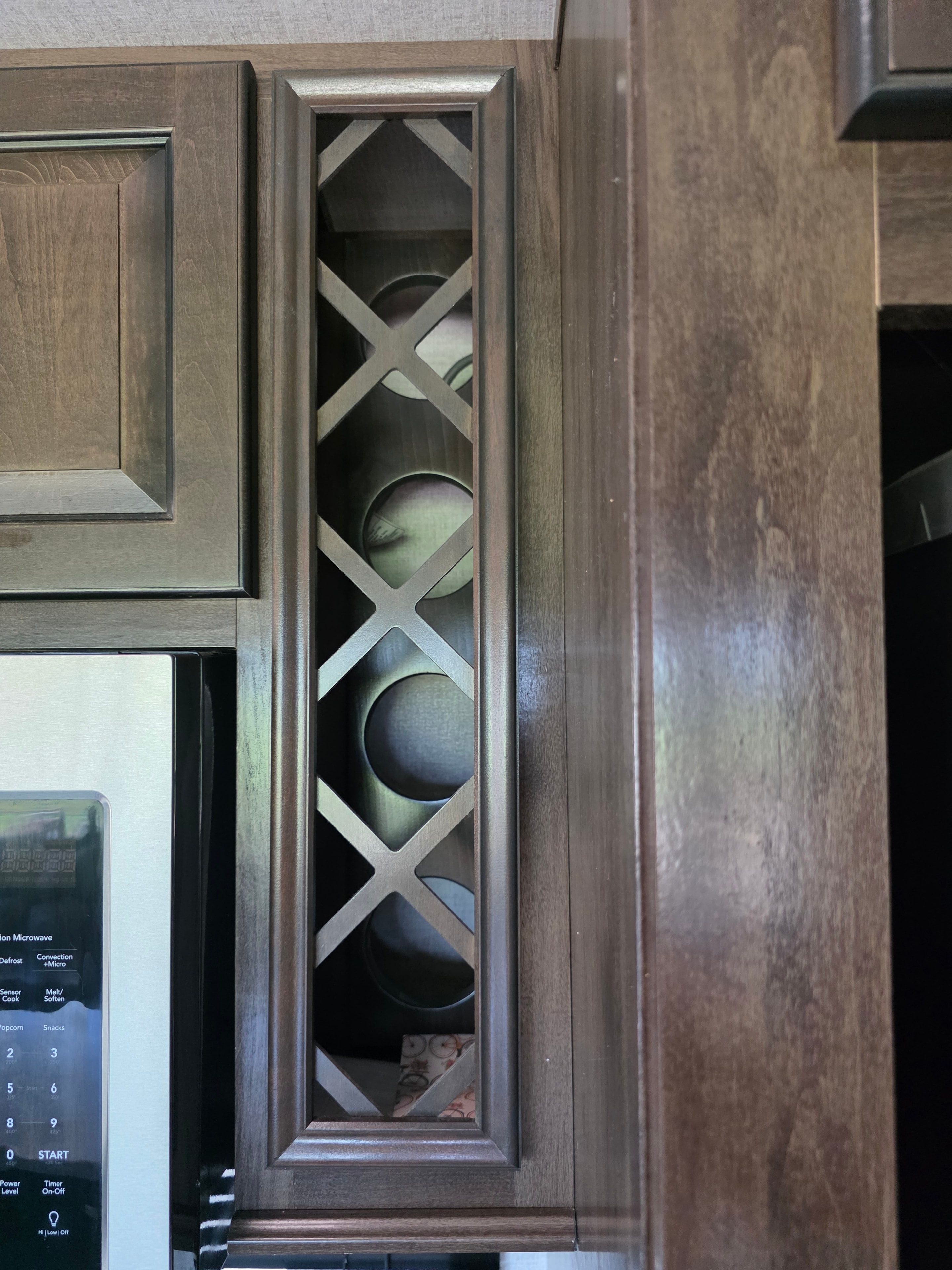 2021 Yukon Dutchmen 320RL – decorative lattice wine rack cabinet above microwave