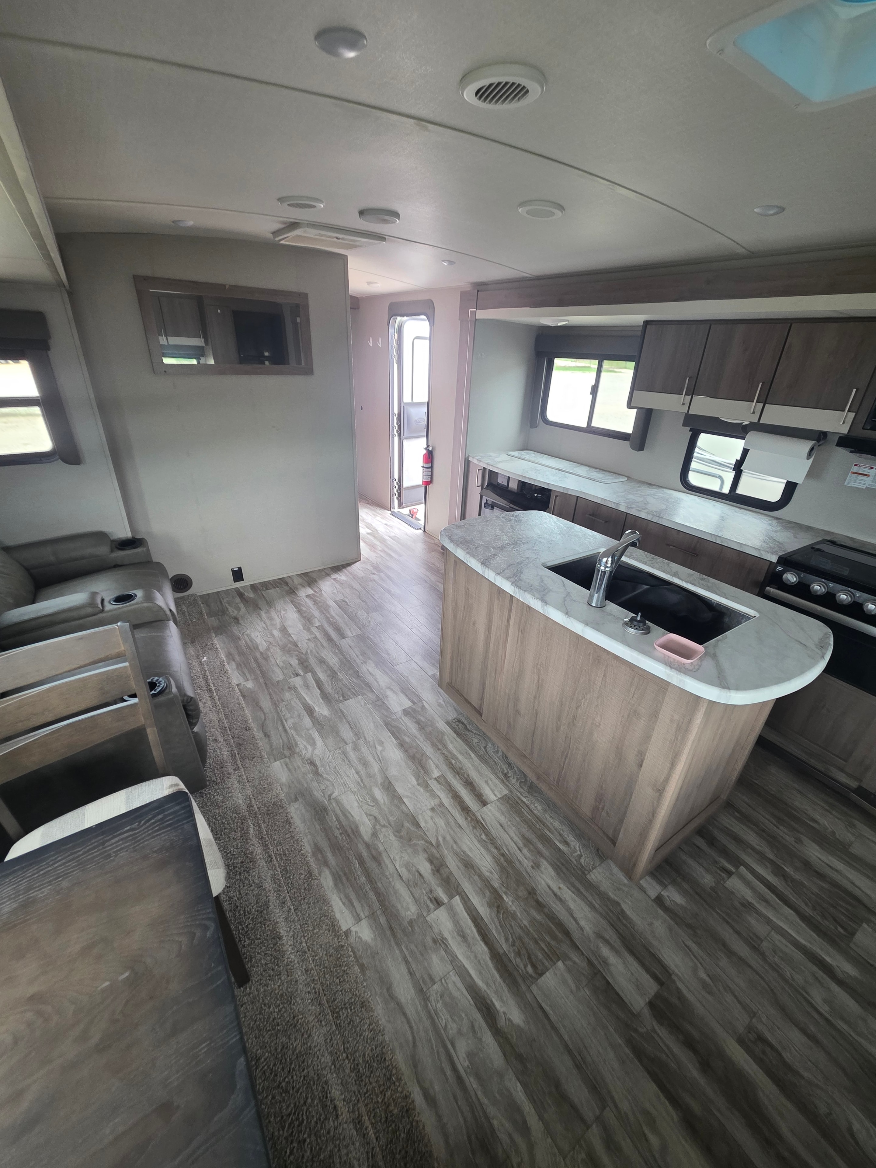 2022 Grand Design Imagine 2670MK – kitchen island close-up with marble countertop, sink and opposing slide view