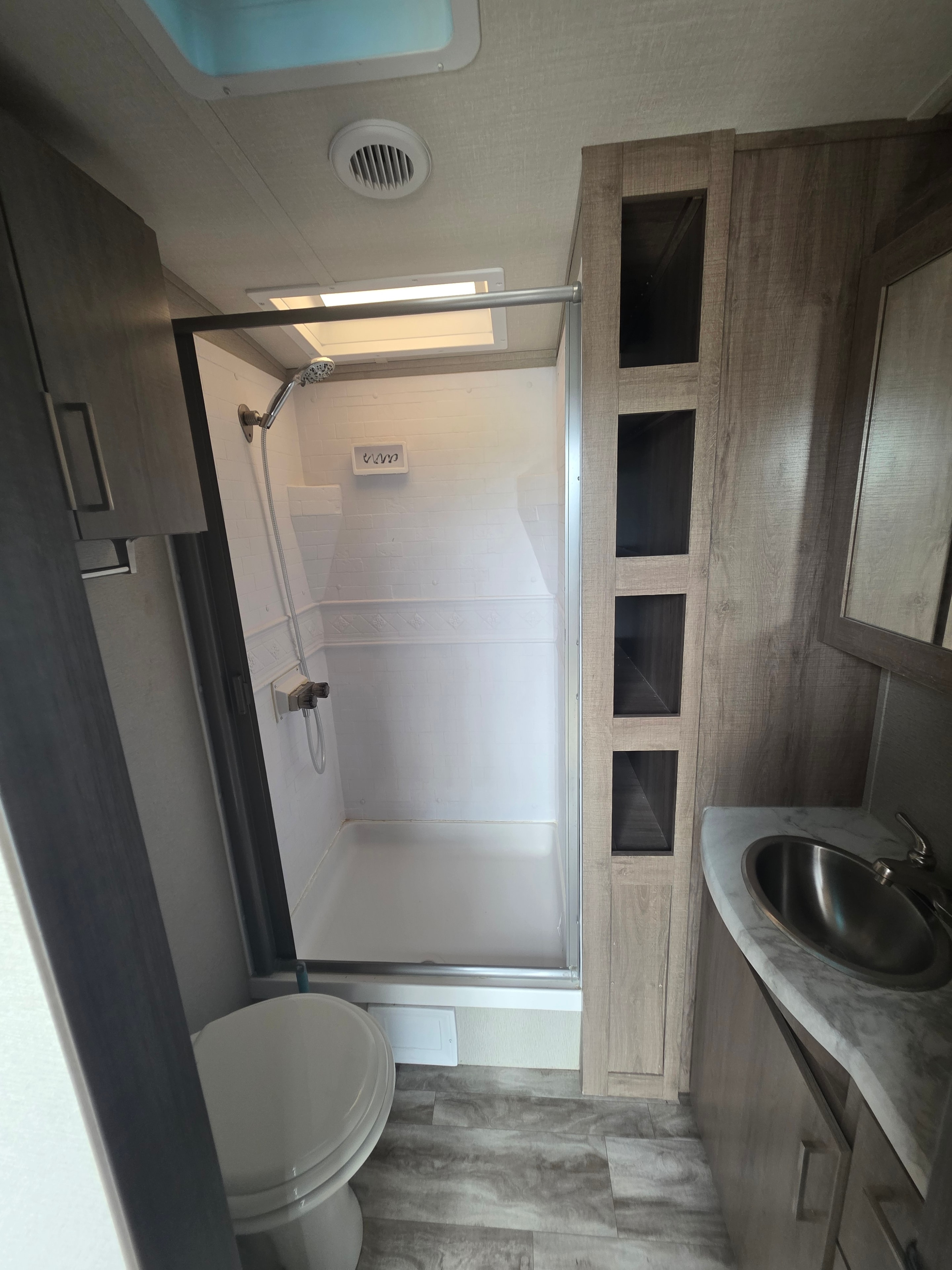 2022 Grand Design Imagine 2670MK – spacious walk-in shower with glass door, overhead cabinets and toilet