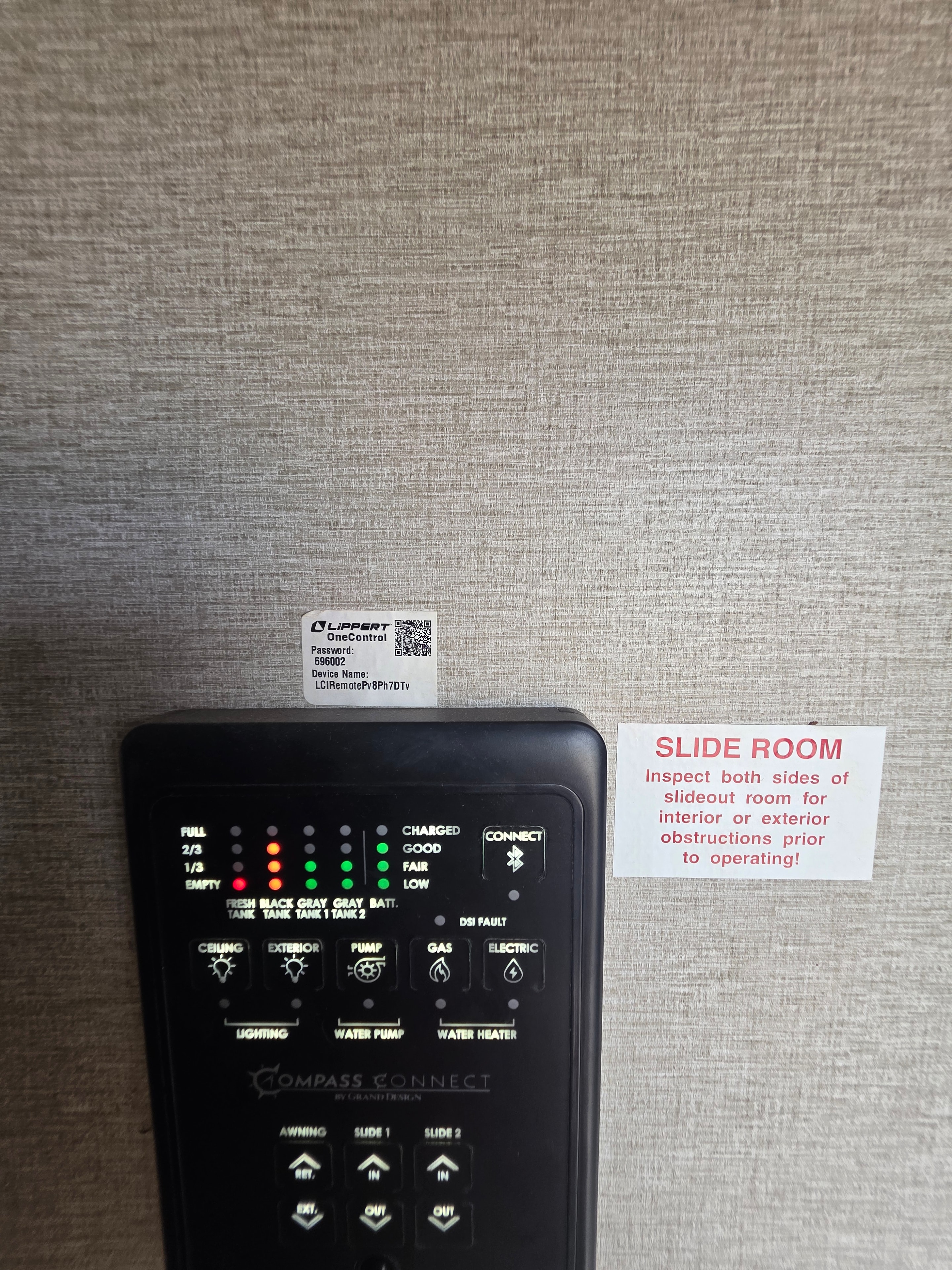 2022 Grand Design Imagine 2670MK – Lippert Compass Connect control panel with slide room warning label