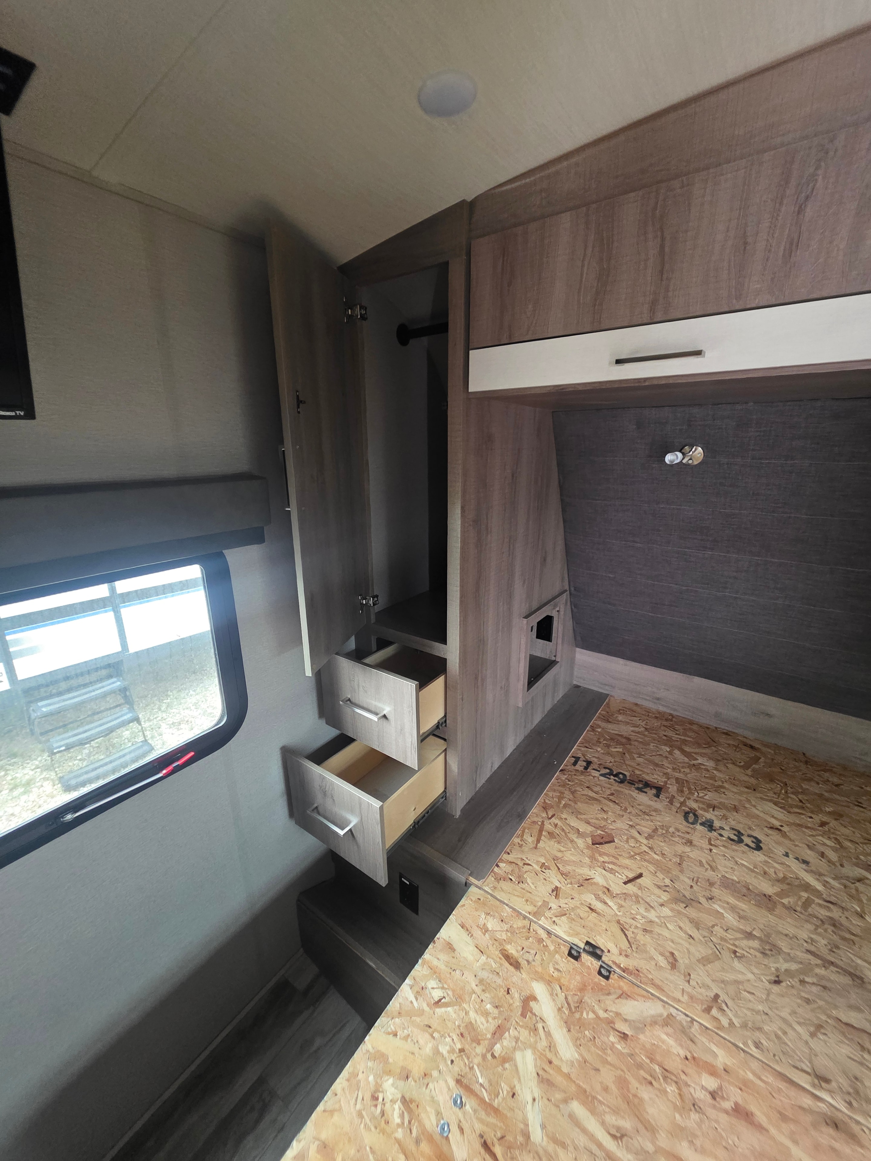 2022 Grand Design Imagine 2670MK – bedroom with built-in desk, USB charging station, drawers and OSB wall