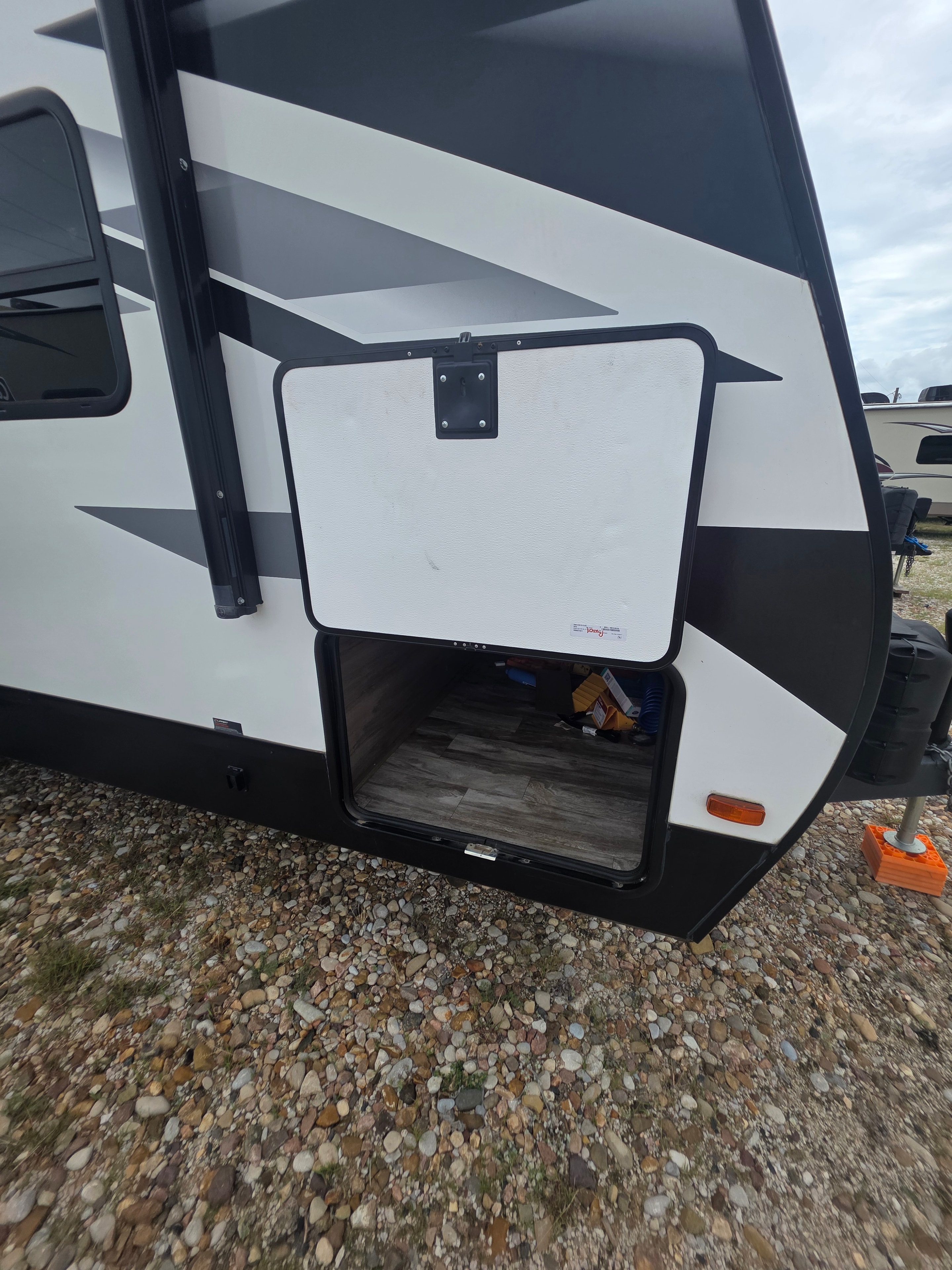 2022 Grand Design Imagine 2670MK – front cap pass-through storage compartment open showing interior