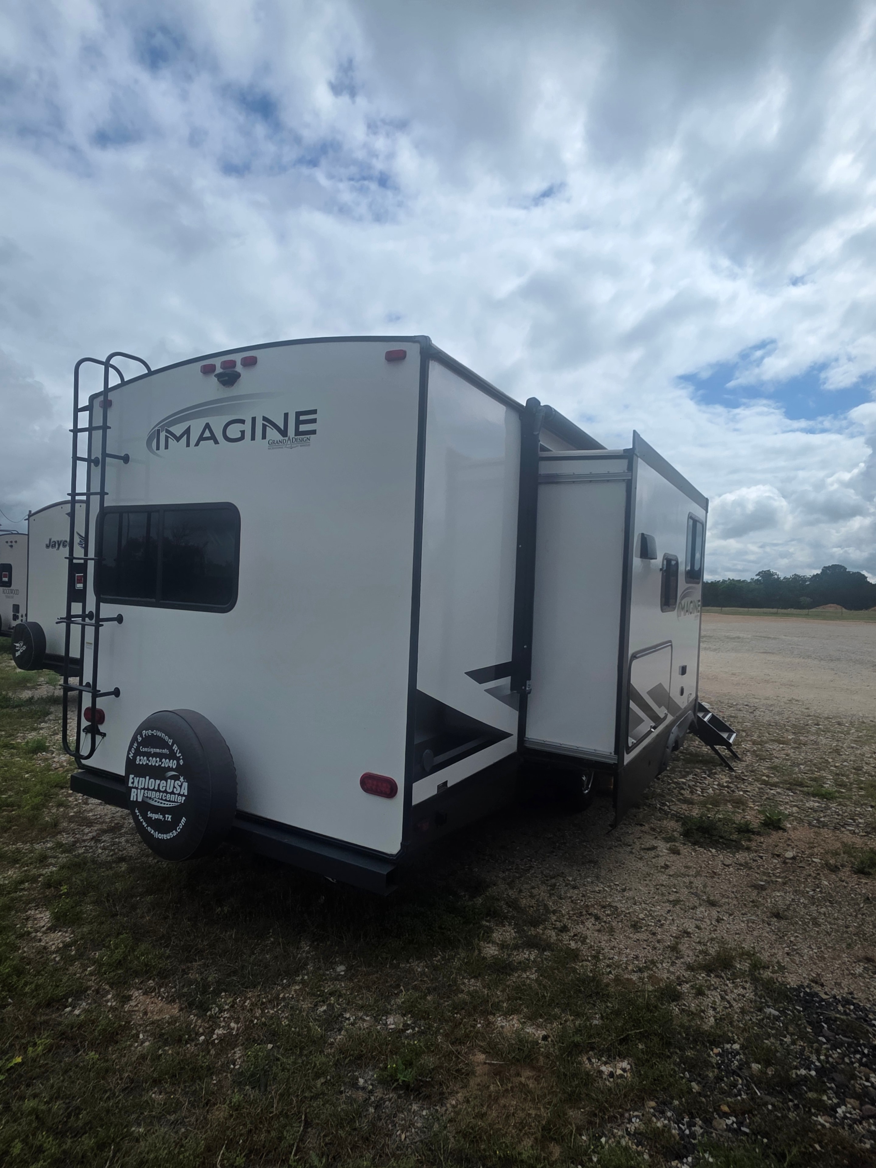 2022 Grand Design Imagine 2670MK – rear quarter with Imagine badge, roof ladder and spare tire