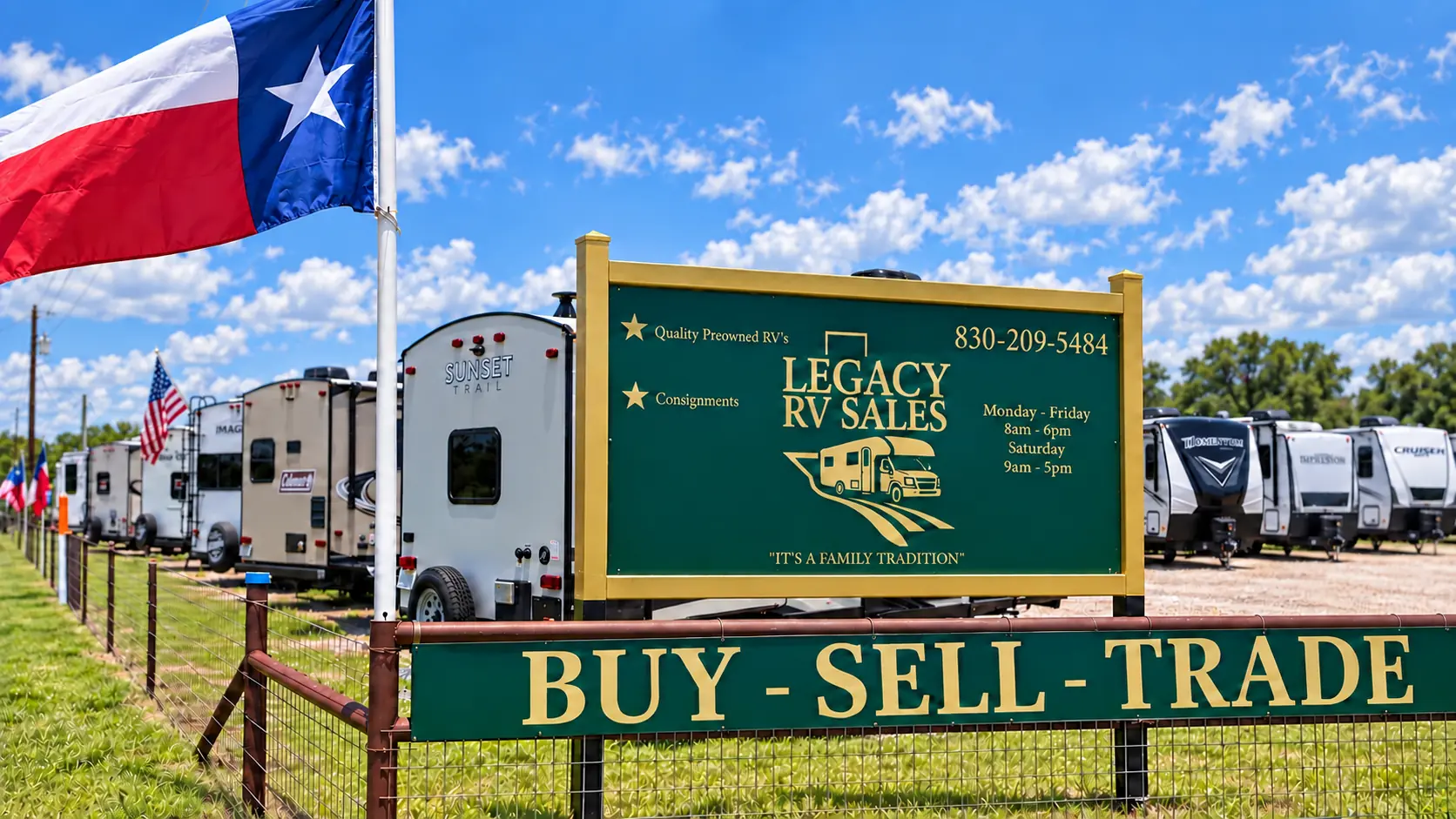 Legacy RV Sales green-and-gold sign with office phone 830-209-5484, Texas flag, and rows of RVs in Fredericksburg, Texas
